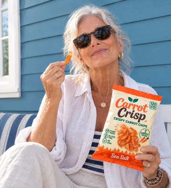 Older woman in sunglasses on a porch swing eating Carrot Crisp